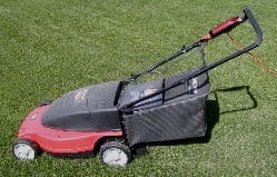Electric lawn mower on a cut lawn