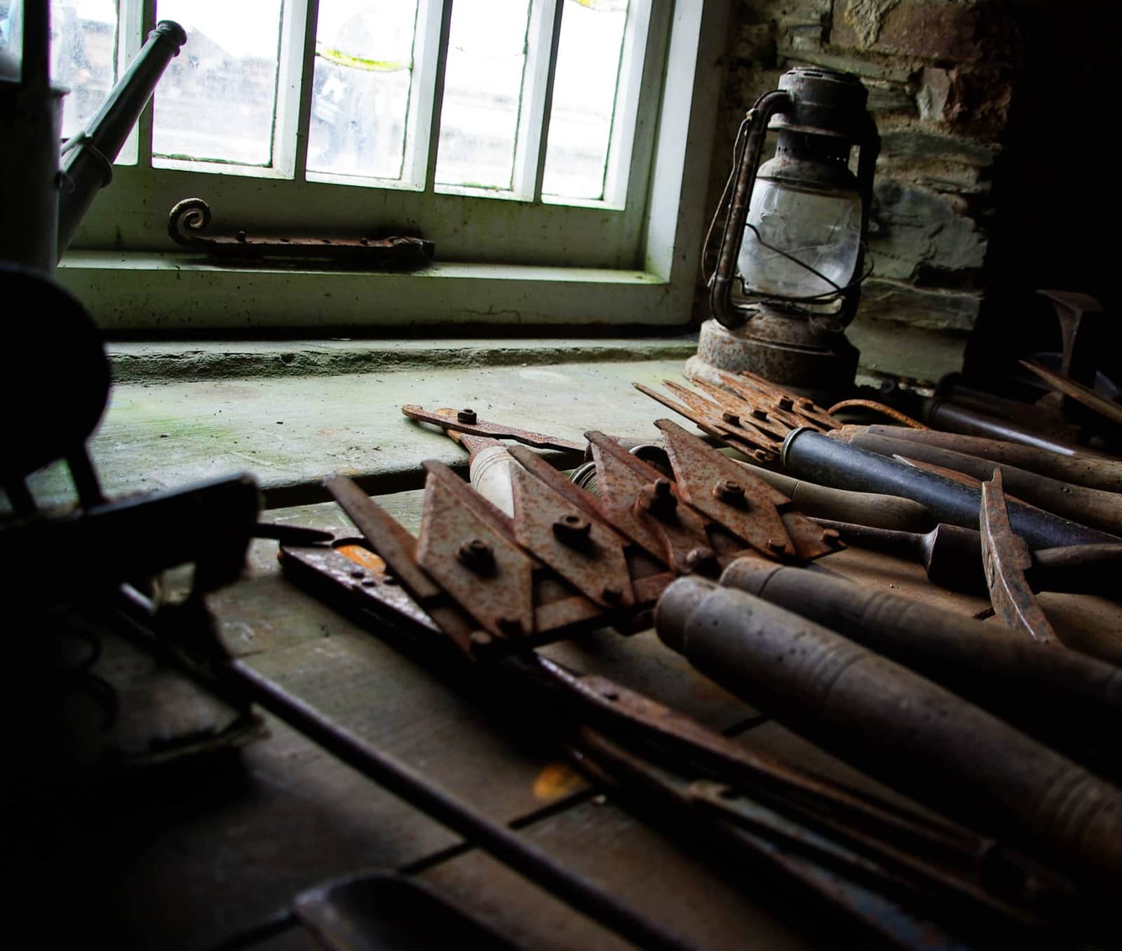 Garden tools hanging in a workshop